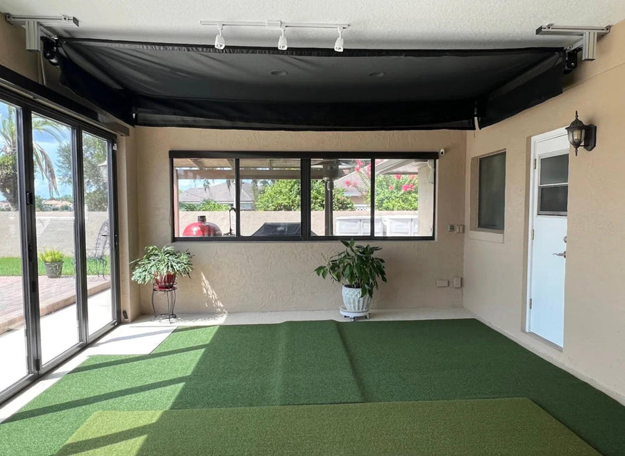 Manual retractable golf impact screen in a garage golf setup