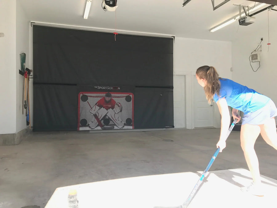 Girl shooting on SportScreen in garage 
