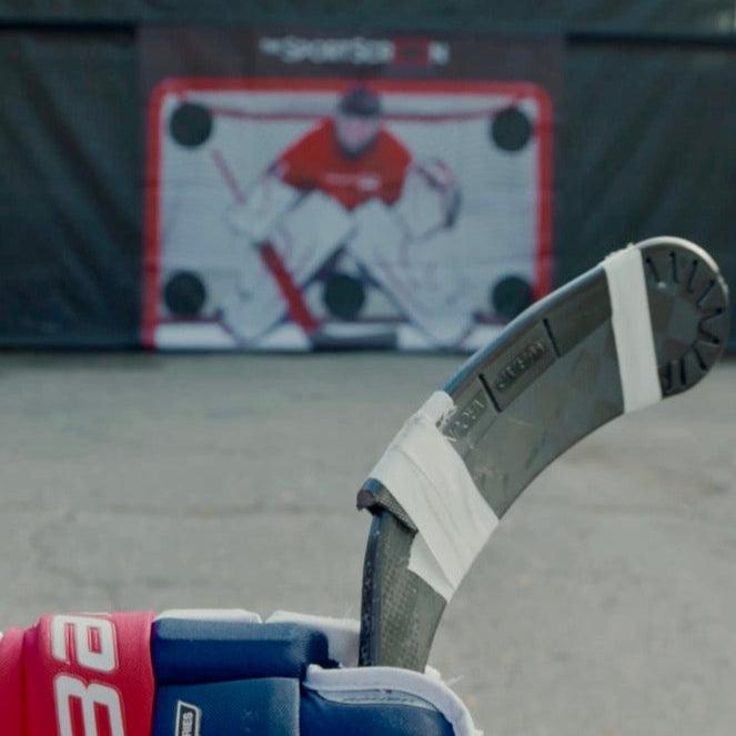 Hockey wraparound blade in black in front of SportScreen being used for driveway hockey play