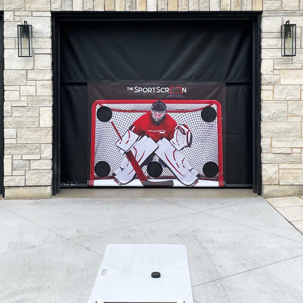 The SportScreen mounted around garage rails, rolling down from the interior of the garage and maintaining the facade of the house.