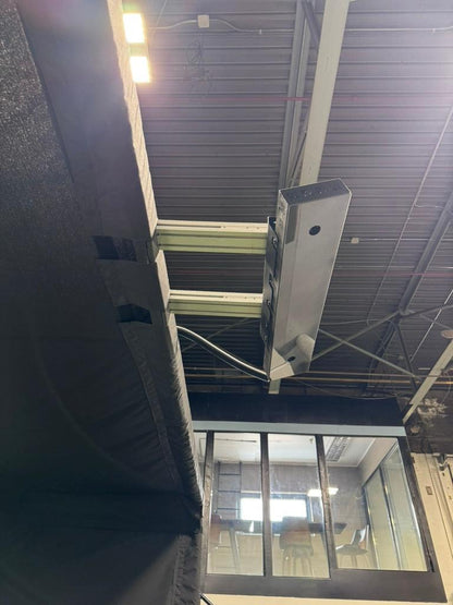 Under-mount view of the Parlour Series Launch Monitor Bracket attached to the golf enclosure frame