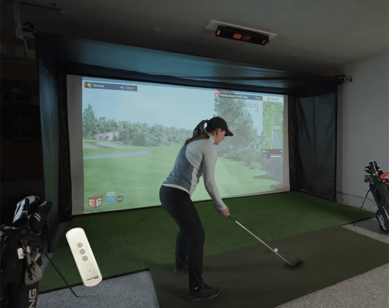 The Vanish Series retractable golf impact screen – a high-end, versatile garage golf studio enclosure with a sleek, roll-up design that easily transforms your space from a professional screen golf setup to an open area.