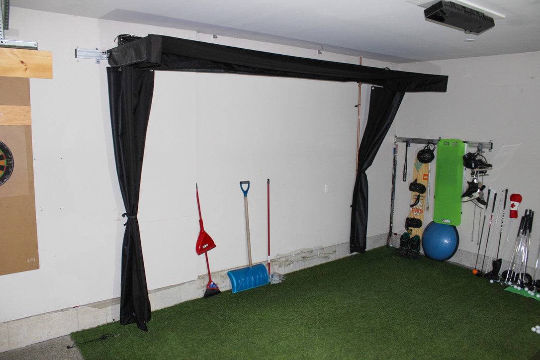 Indoor golf practice area with artificial grass, golf clubs, and sports equipment.