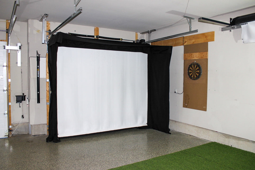 Garage with a retractable screen wall and a dartboard on the wall.