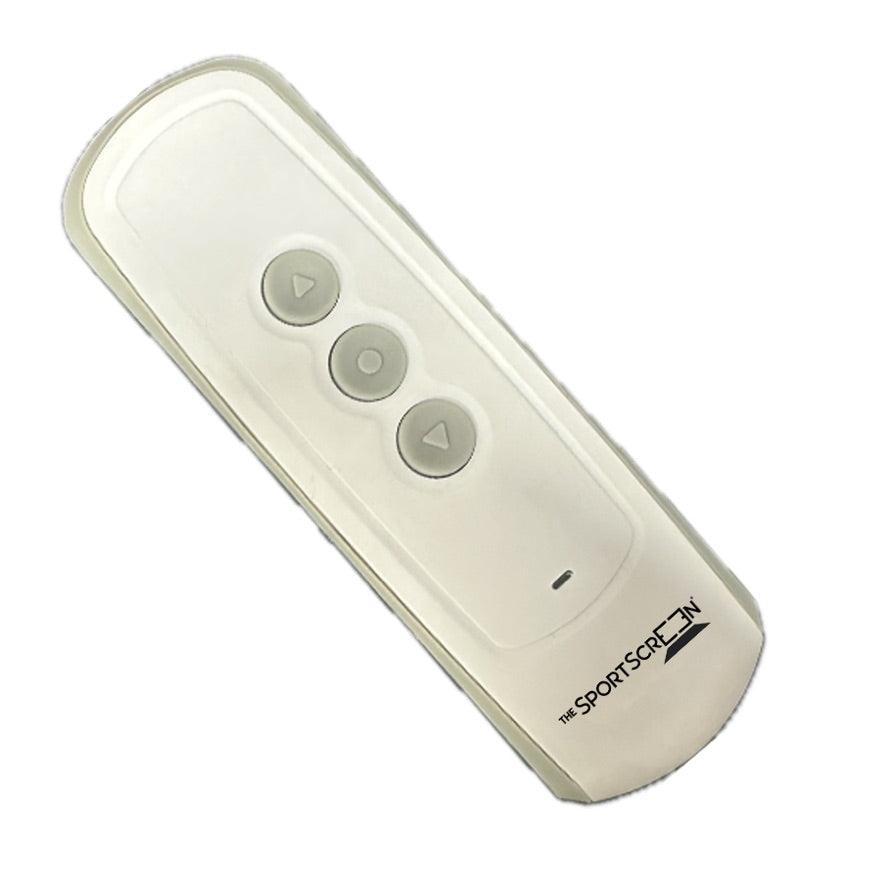 A close-up of a remote control with buttons for operating a retractable golf or hockey screen.