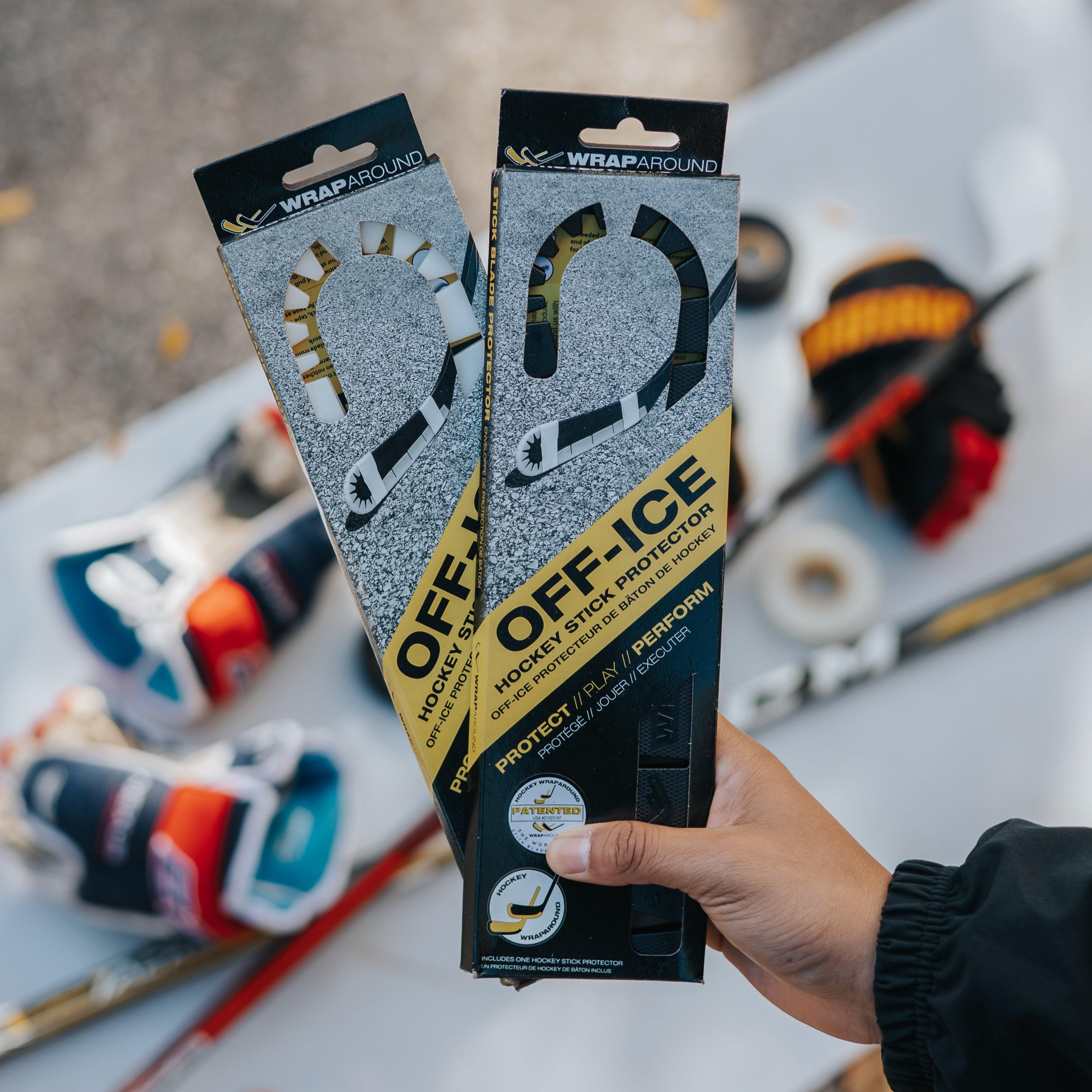 Wraparound hockey blades for off-ice stickhandling in black and white with shooting pad and hockey gloves and sticks in background