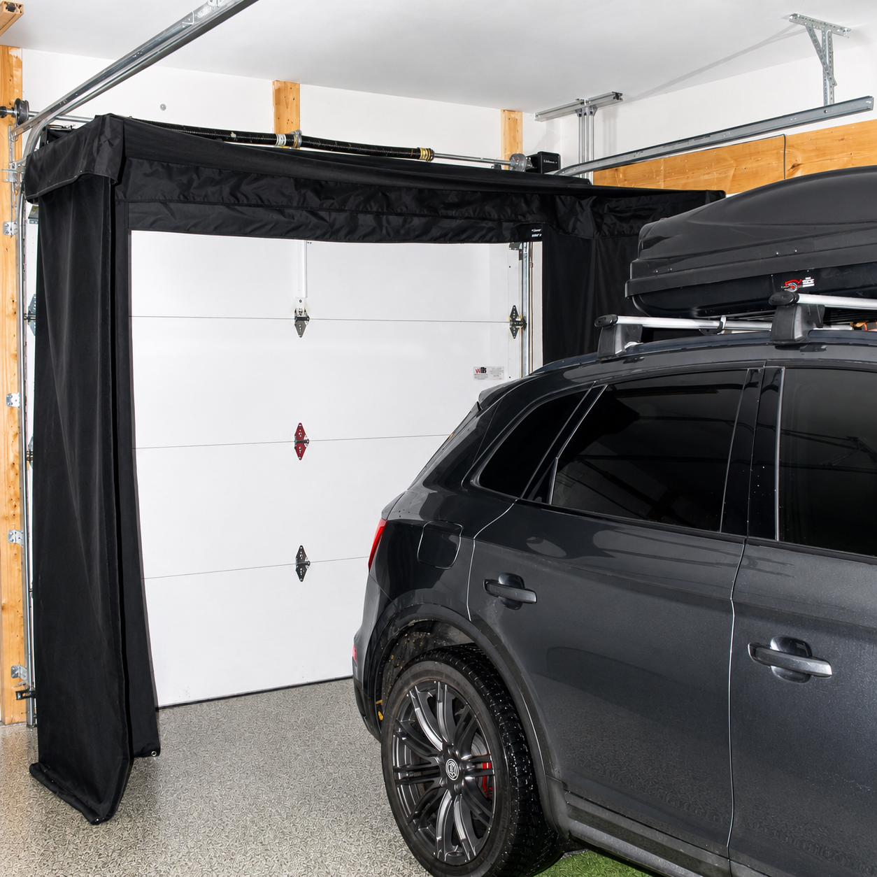 Vanish Lite 11 retractable golf impact screen mounted around garage rails with a car parked