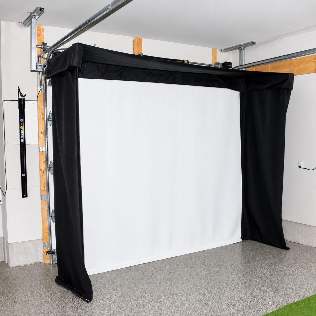 Vanish Lite 11 golf impact screen semi-retracted, mounted around garage rails