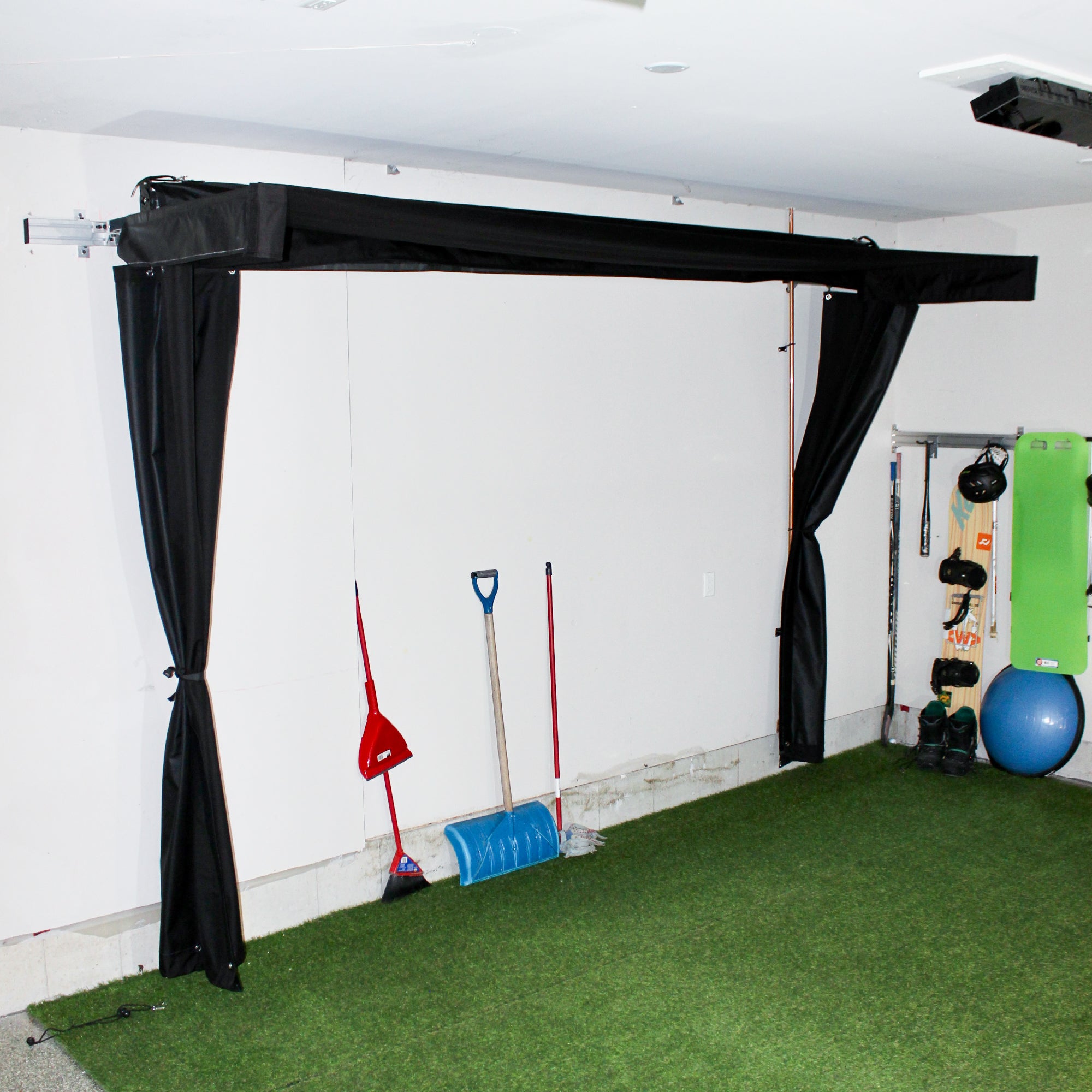 Vanish Lite 13 golf impact screen pinned back inside a garage